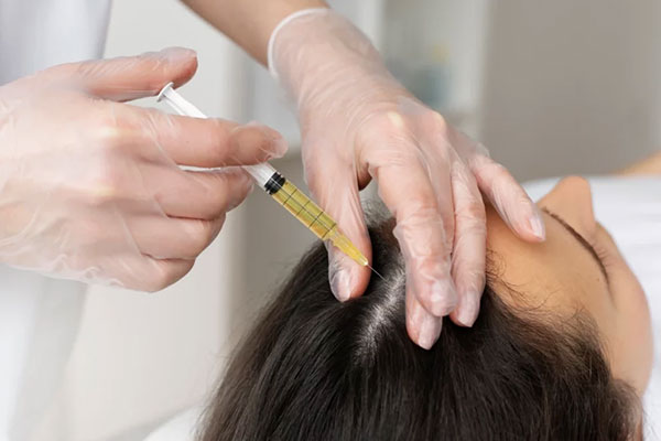Gloved clinician performing a PRP skin rejuvenation procedure on a client