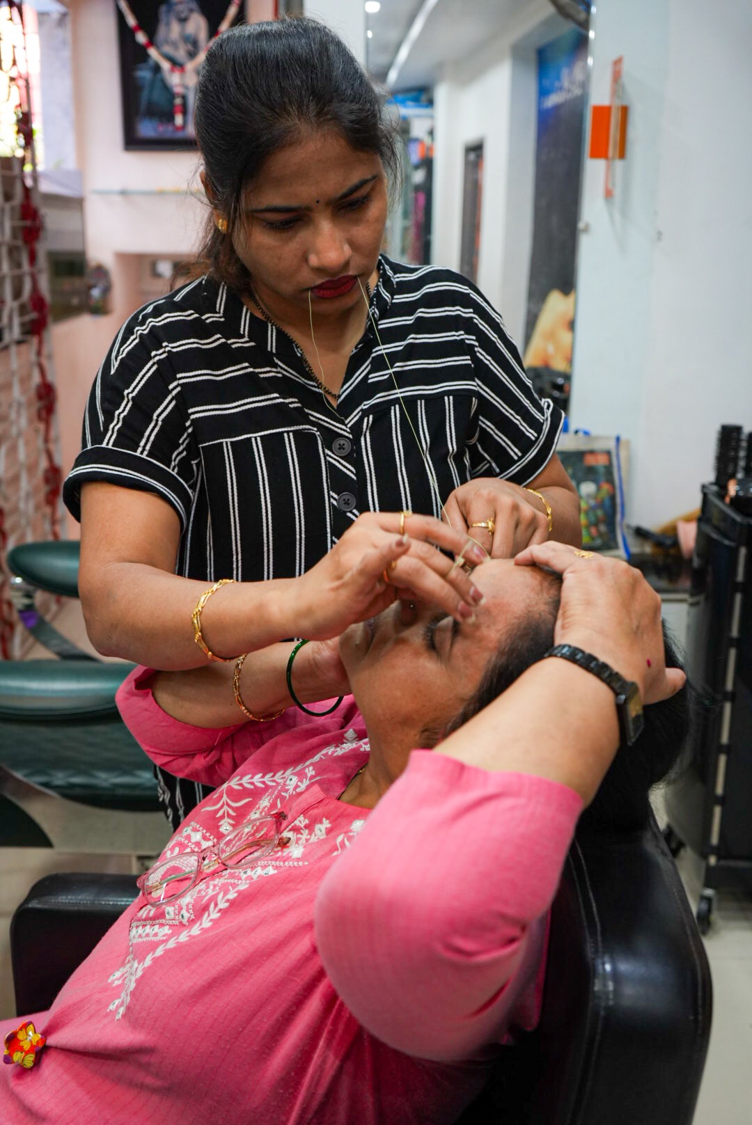 Eyebrow threading performed by a beauty expert